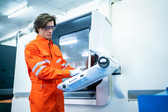 Mechanical engineer using coordinate measuring machine CMM measurement technologies at production line in the industry factory.
