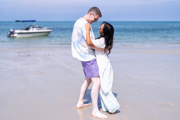 Love couple on holiday happy playing running along the beach and sweet kiss on love emotion