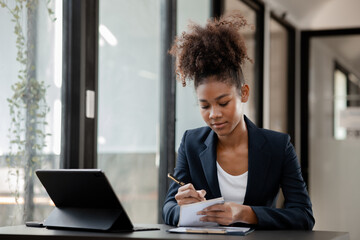 American woman sits in the office of a startup company, she is a company employee, young generation operations run the company with the concept of the new generation. Company management concept