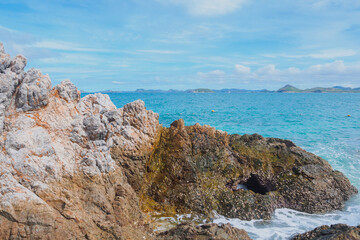 Rock on the beach with emerald sea and clear blue bright sky with copy space at Kham Island (Koh...