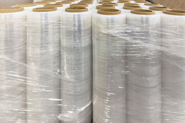 Roll of industrial packaging film. Stretch film in rolls stands in a row. The use of film as a...