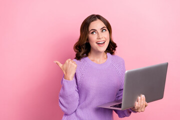 Photo of positive lady wear stylish comfort clothes thumb demonstrate modern device shop empty space isolated on pink color background