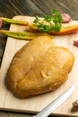 Smoke-smoked chicken is cut up on a board