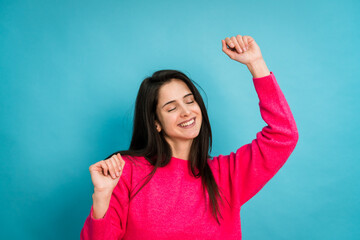 Fototapeta premium Smiling woman dancing and listening music