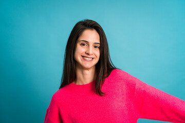 Fototapeta premium Smiling woman in sweater looking at camera