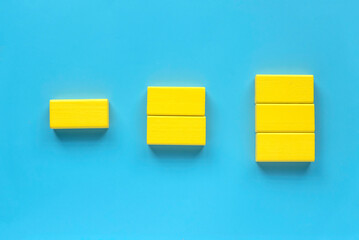 Category concept. Different shape of yellow wooden geometry block rearrange into its category.