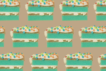 Green kitchen cleaning sponge as a sponge cake with whipped cream and colourful sprinkles on yellow beige background. Creative concept of holiday celebrating. Happy birthday wallpaper. Household.