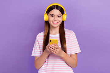 Photo of pretty adorable lady wear striped white t-shirt listening music modern device isolated violet color background