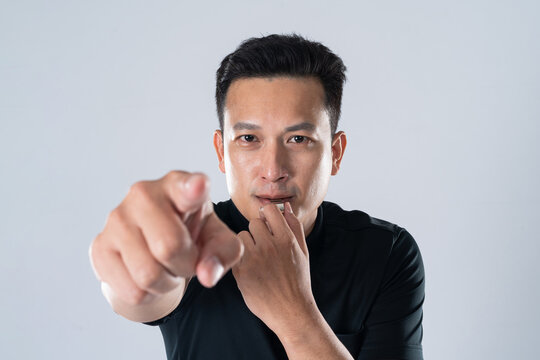 Football referee holding whistle and pointing with isolated hand.