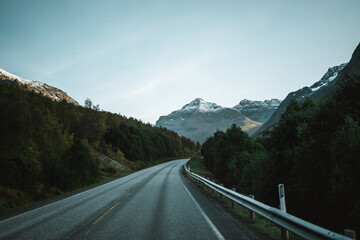 Empty road with a view on majestic mountains and the norwegian landscape in autumn