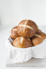 Pretzel buns in a napkin lined basket, German laugenbroetchen, lye buns in a basket