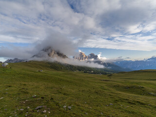 Fototapeta na wymiar Ra Gusela mountain at Passo Giau surrounded by low clouds and fog