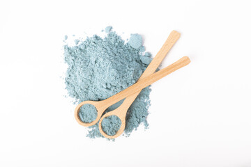 Blue spirulina powder in spoon isolated on white background. Natural vegan superfood. food...