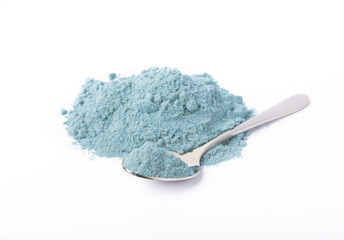 Blue spirulina powder in spoon isolated on white background. Natural vegan superfood. food...