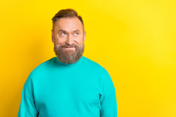Photo of retired man wear bright teal pullover look empty space special proposition isolated on yellow color background