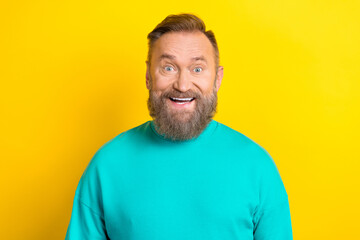 Photo of astonished cheerful man wear bright aquamarine trendy clothes impressed special deal offer isolated on yellow color background