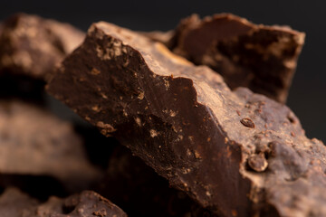 Pieces of chocolate with added cocoa and sugar