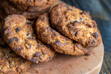 Delicious cookies with pieces of chocolate on the table