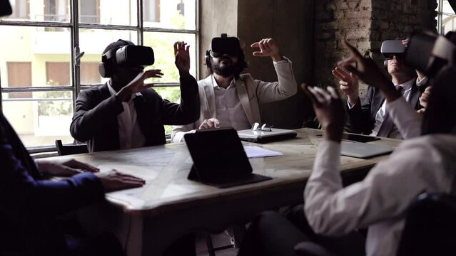 Multiracial business people wearing virtual reality futuristic goggles inside office