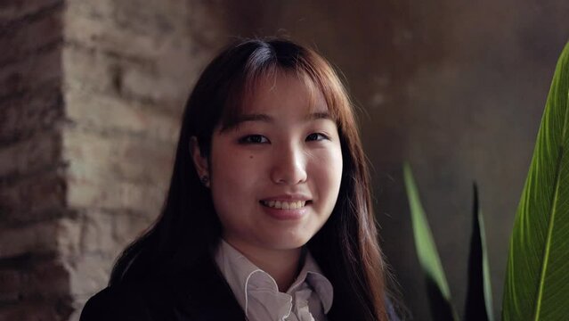 Portrait of happy Asian business senior woman working inside office