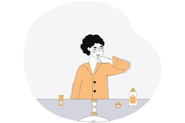 A boy in pajamas brushes his teeth in the bathroom. Healthy teeth. Oral hygiene.