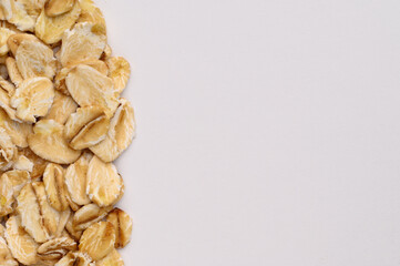 Macro photo of oatmeal on a white background,texture,background. Healthy, tasty food, a source of amino acids, minerals.