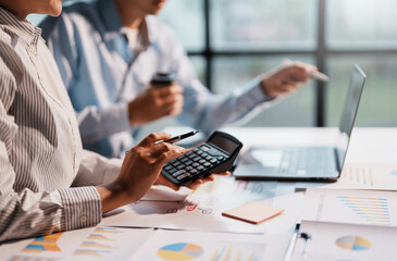 Businesspeople meeting to plan, analyze about business growth to plan future new business expansion using laptop and tablet computer for work.
