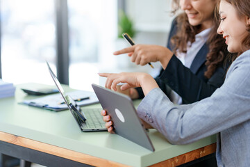 Businesspeople meeting to plan, analyze about business growth to plan future new business expansion using laptop and tablet computer for work.