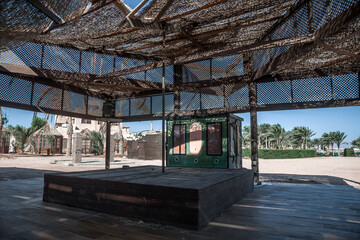 Old abandoned bar on the beach. Wooden interior. Old shabby walls. Sunny day. Sand on the beach. Forgotten beach bar.