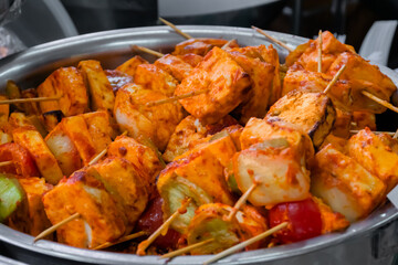 Fresh colorful vegan Paneer Tikka - Indian appetizer made with cubes of paneer, tomato, zucchini,...