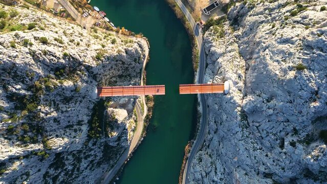 Aerial drone view of Unfinished bridge in Omis, Croatia over the river Cetina. Bridge being built in between the canyon. Industrial and complex construction in the Dalmatia area. 