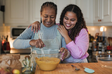 African mother and daughter cooking together at home