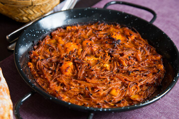 Fideua with squid and seafood. Typical Spanish tapa cooked with paella.