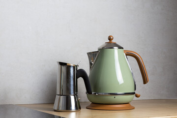 a stylish electric kettle and geyser coffee machine stand in the kitchen