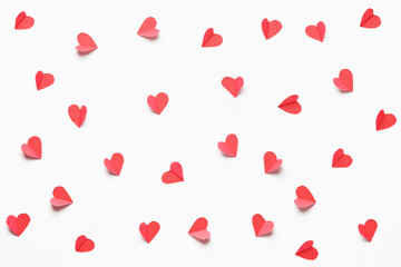 Fototapeta na wymiar Hearts cut out from white paper. Festive background for valentine's day.