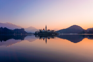 Naklejka na ściany i meble Dramatic winter sunrise on Lake Bled with the surrounding mountains