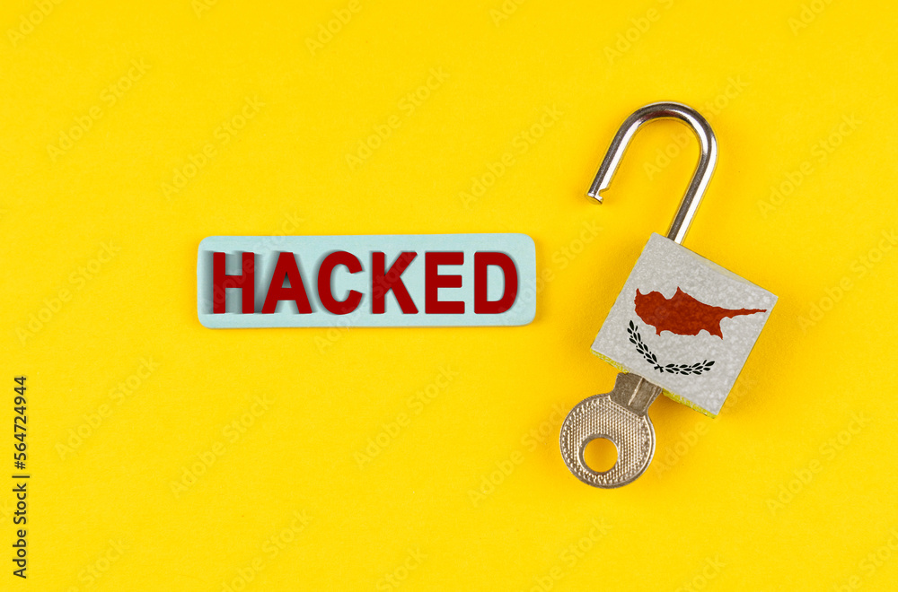 Poster on the yellow surface is an open lock with a key and a sticker with the inscription - hacked