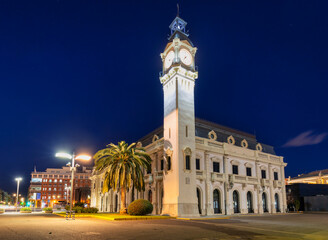 Night landscape of the Port of Valencia with the clock tower, Spain. - obrazy, fototapety, plakaty