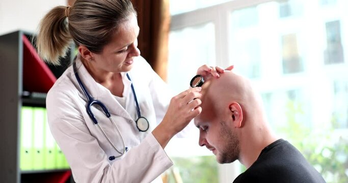 Doctor trichologist examining skin on head of bald man 4k movie slow motion 