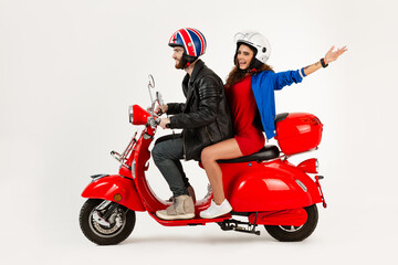 young attractive couple riding an electric motorbike scooter happy having fun together
