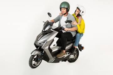 young attractive couple riding an electric motorbike scooter happy having fun together