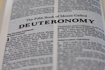 Obraz premium Deuteronomy, the fifth book of Moses from the bible, title page image with bokeh, Old Testament or Torah for Christian and Jewish religion