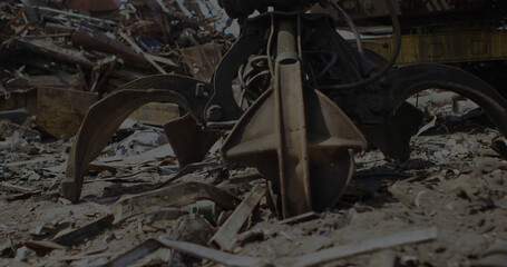Close up of metal claw working at rubbish dump
