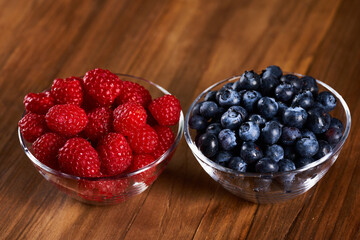Raspberries and blueberries on an wooden board