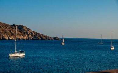 Sailboats off the coast of Santorini at sunset