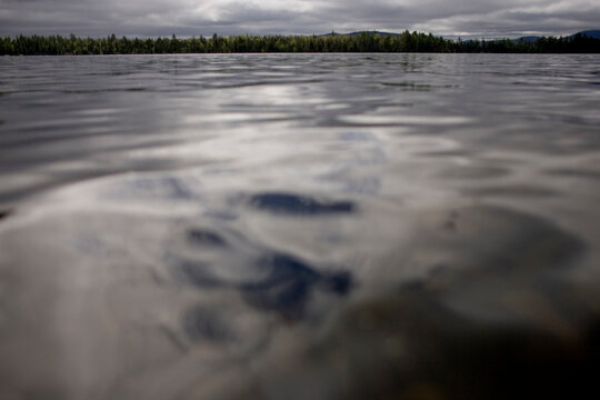 Clouds reflect in Second Roach Pond outside of Greenville, Maine.