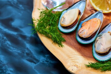 mussels open on a wooden platter