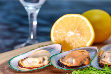 mussels open on a wooden platter
