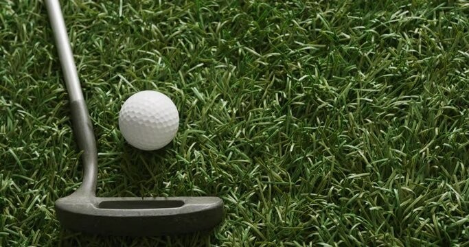 Close up of golf club and balls on grass, copy space, slow motion