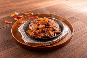 Spicy Sizzling Potato Chips served dish isolated on wooden table top view of Hong Kong food